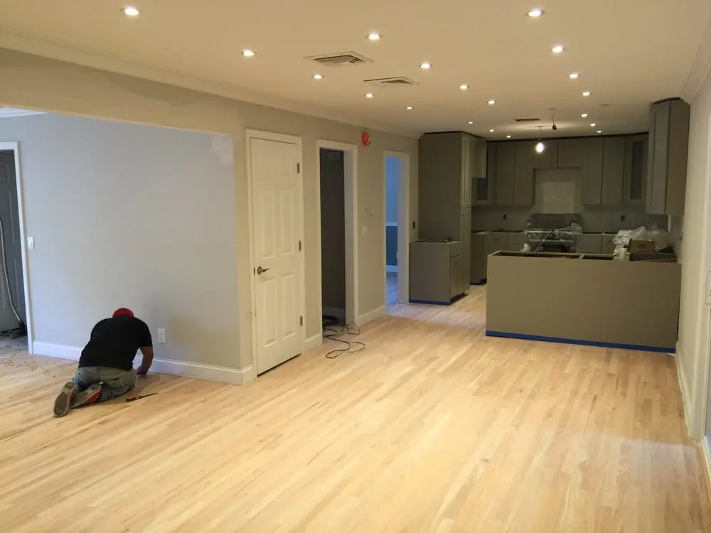Open-plan living area and kitchen with freshly painted walls and trim