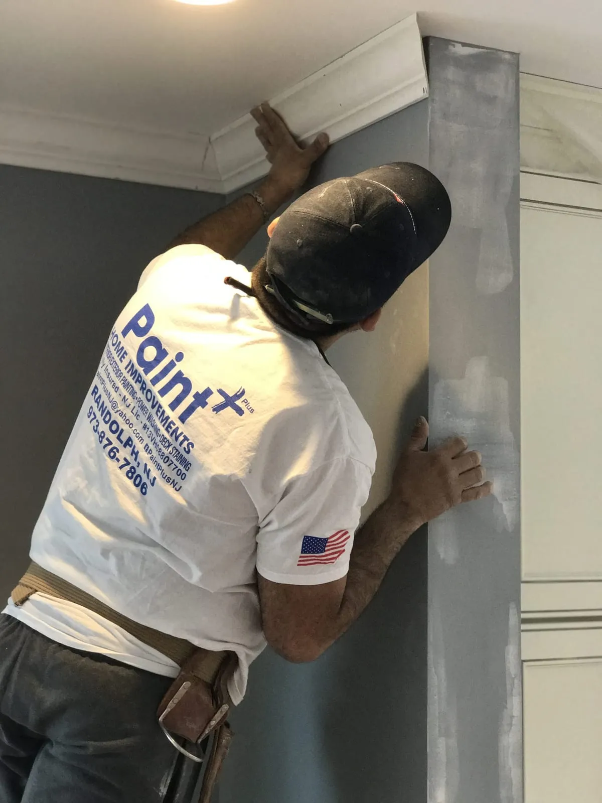 Paint Plus painter smoothing a wall with joint compound before painting