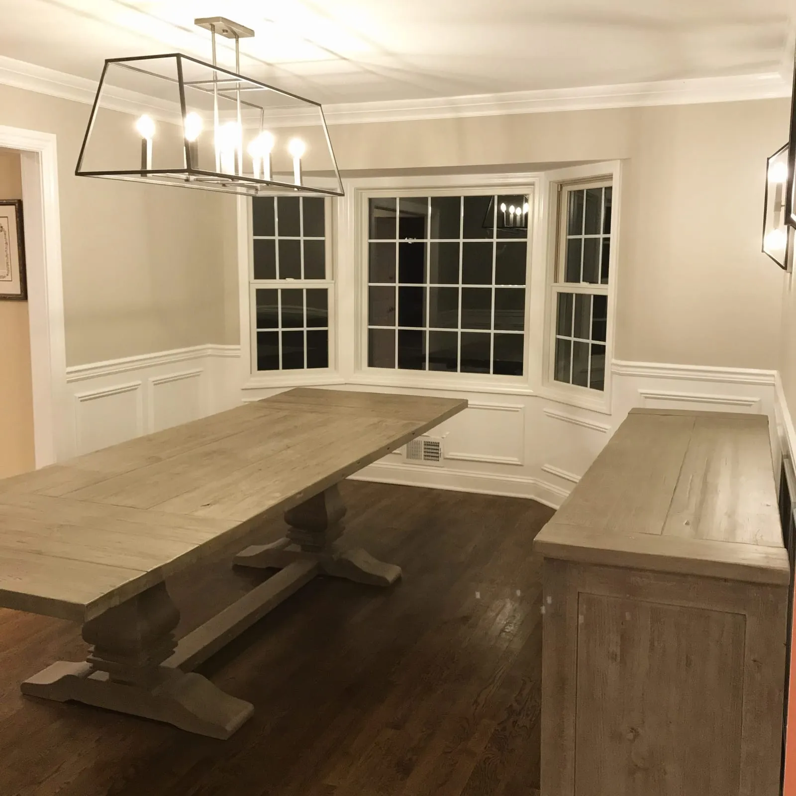 Dining room with fresh white wainscoting, trim and walls, painted by Paint Plus