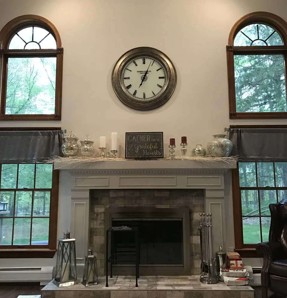 Living room fireplace wall with painted mantel and arched windows, painted by Paint Plus in Mendham, NJ